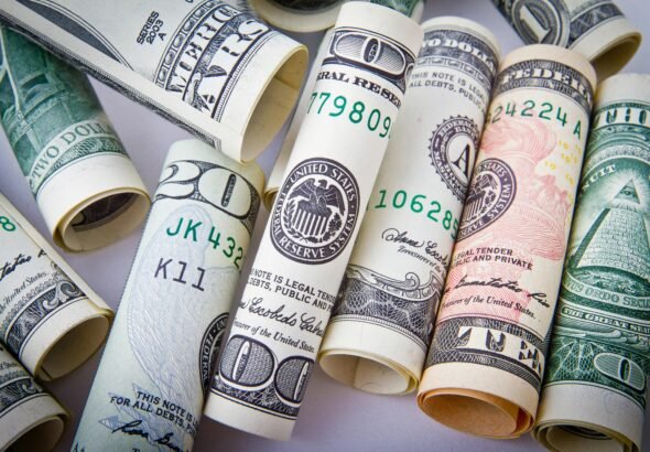 Close-up of rolled US dollar bills symbolizing wealth, financial success, and currency.